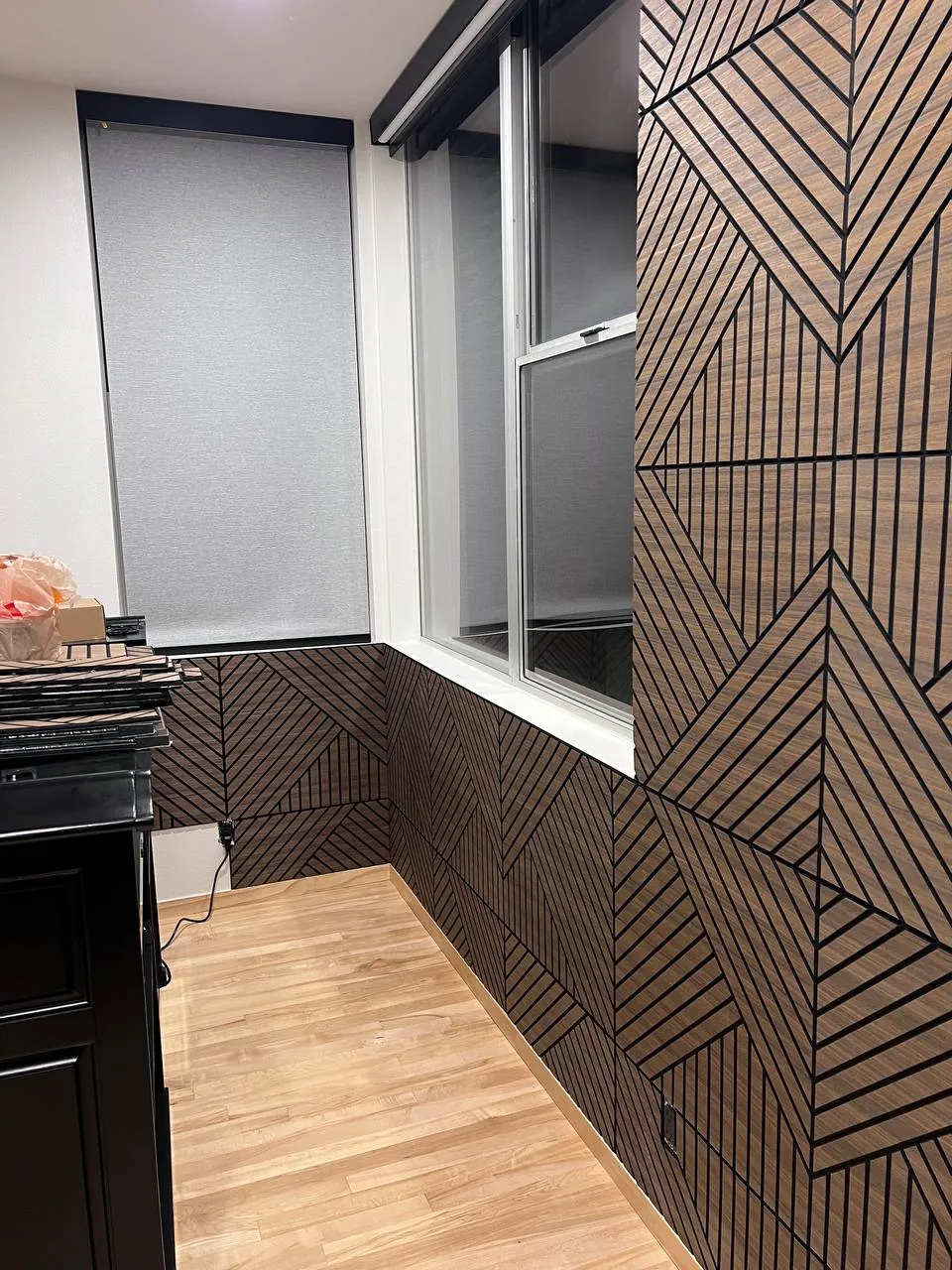 Wood-slat accent wall beside a picture window