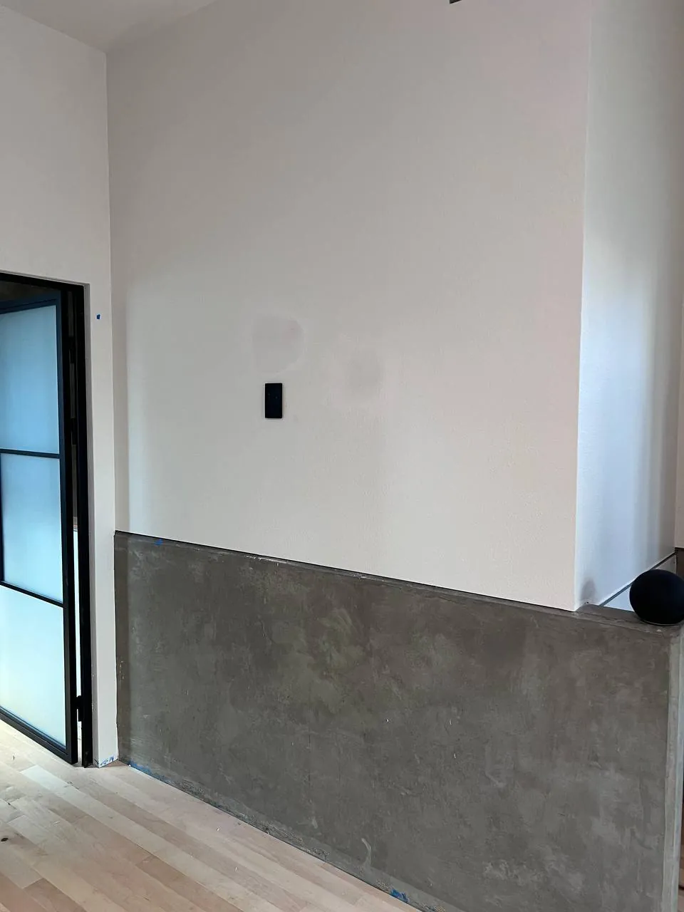 Venetian-plaster accent wall with mounted TV