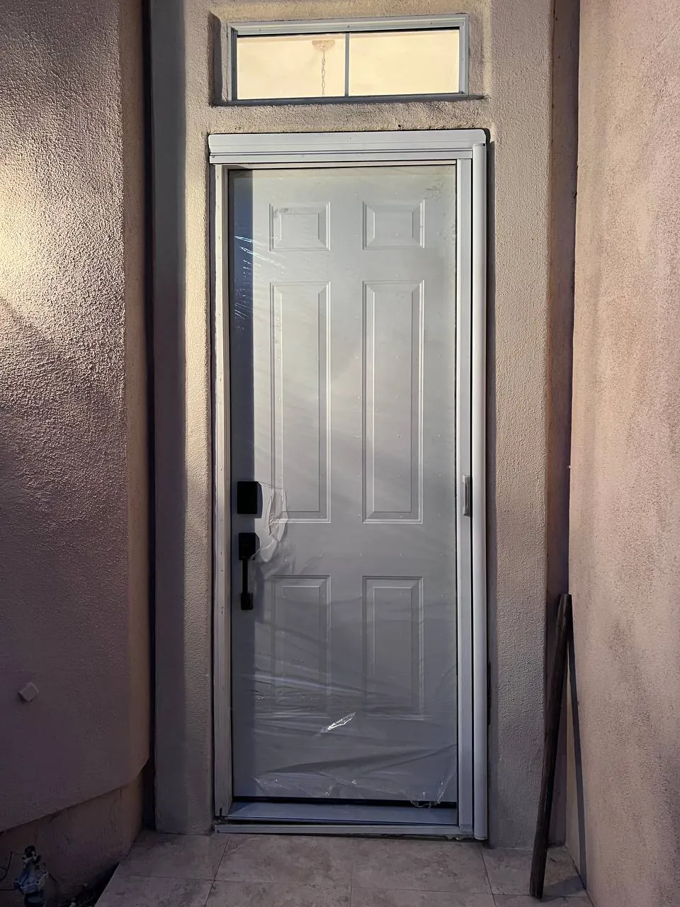 Decorative glass-and-iron entry door installed