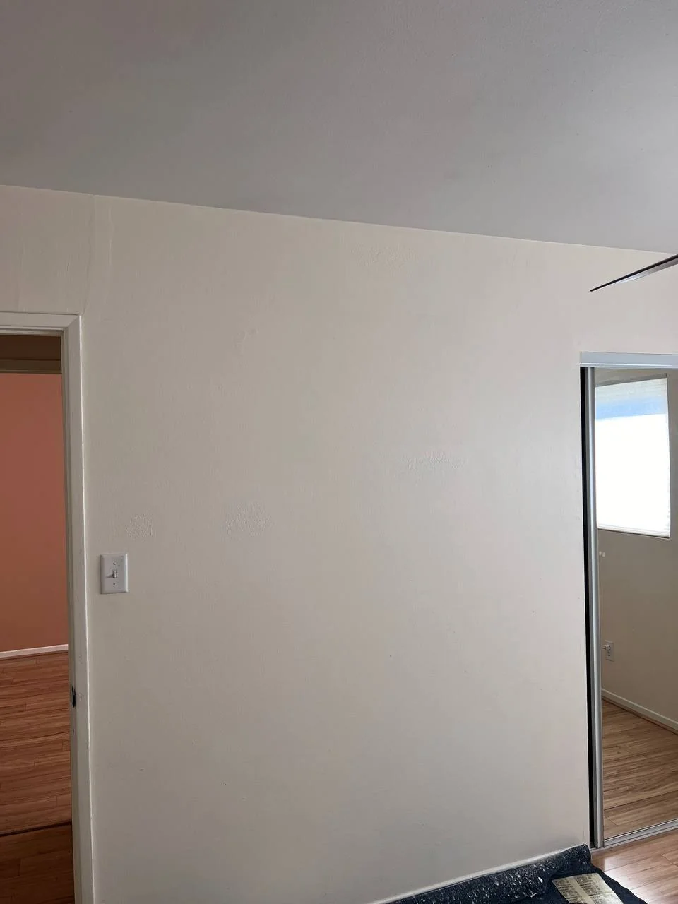 Same San Diego wall after drywall patch and paint — clean, smooth, invisible repair
