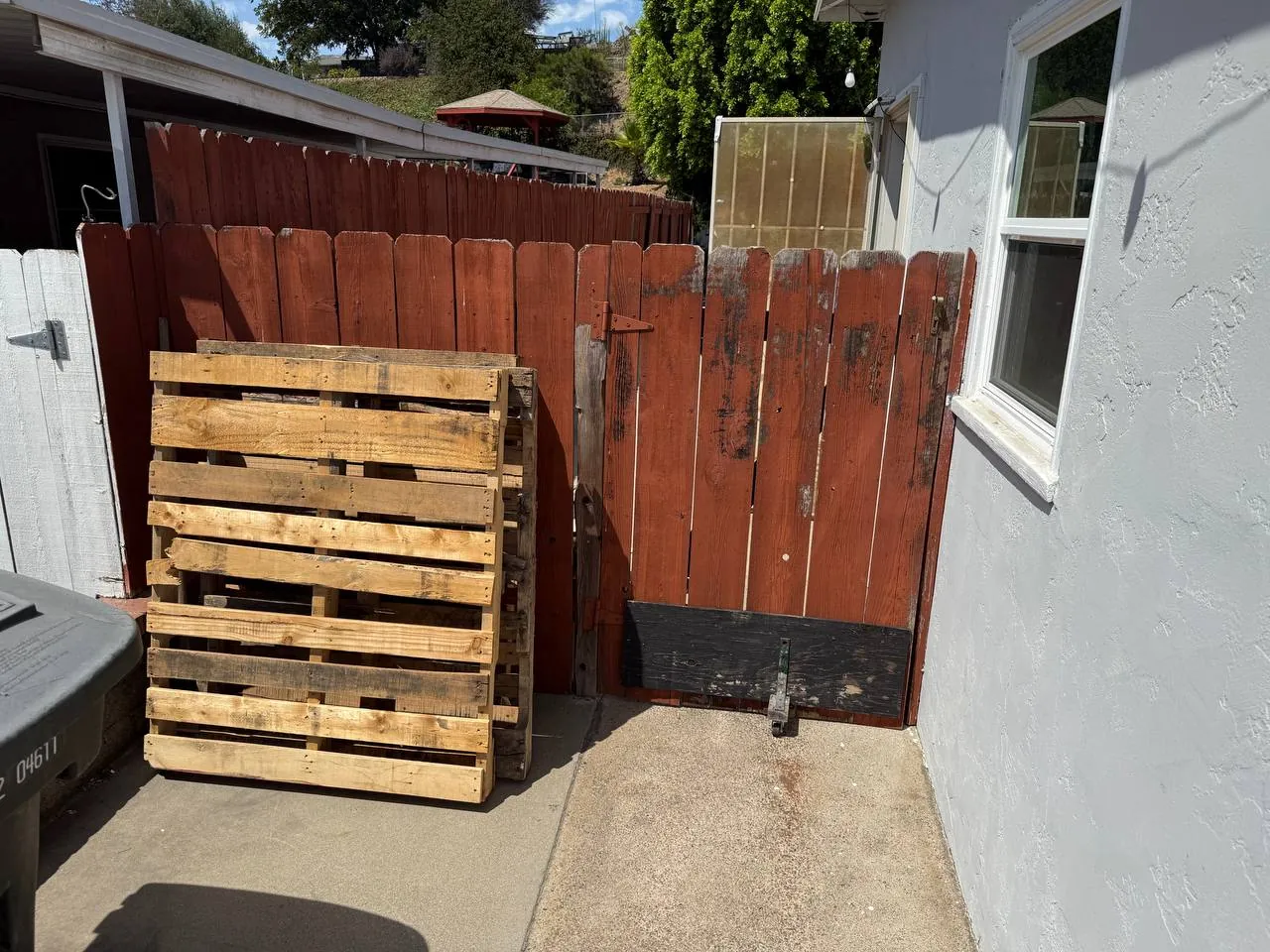 New redwood fence panels installed along a property line