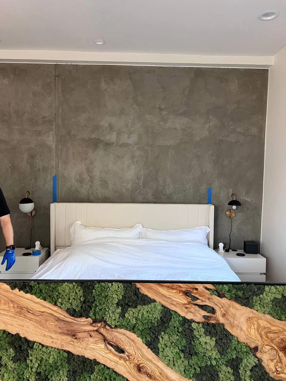 King bed assembled under a scenic mural panel