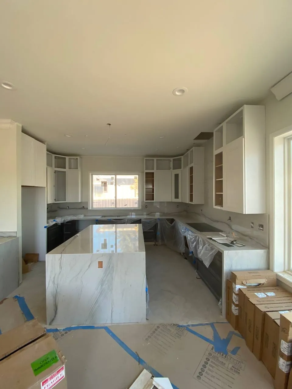 Large white kitchen island with quartz countertop