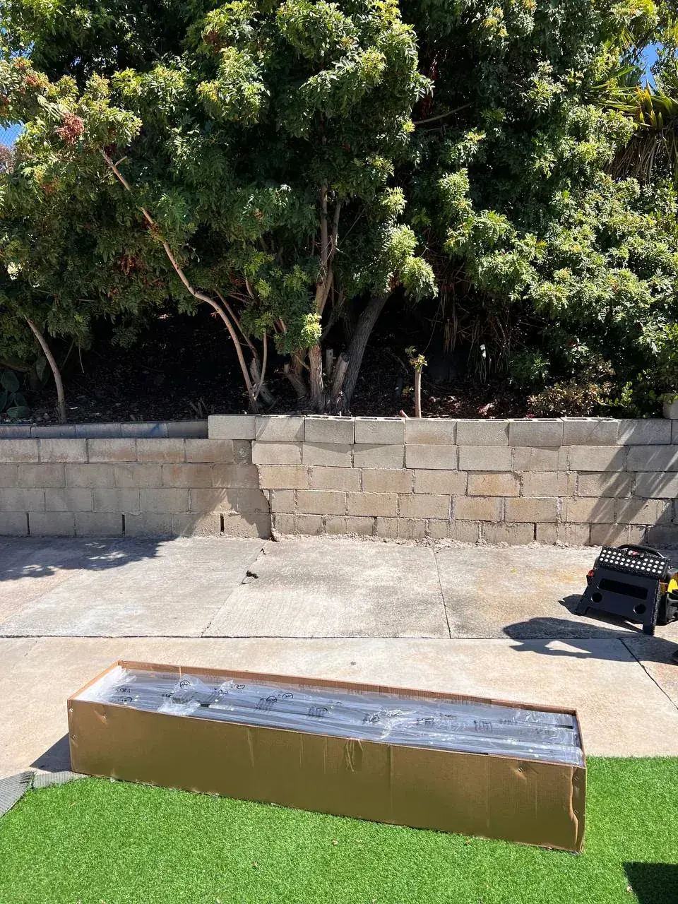 Backyard pavers and artificial turf with a fire feature