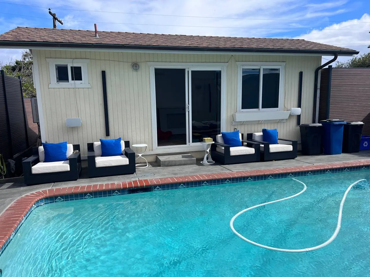 Pool deck with loungers at a remodeled San Diego home