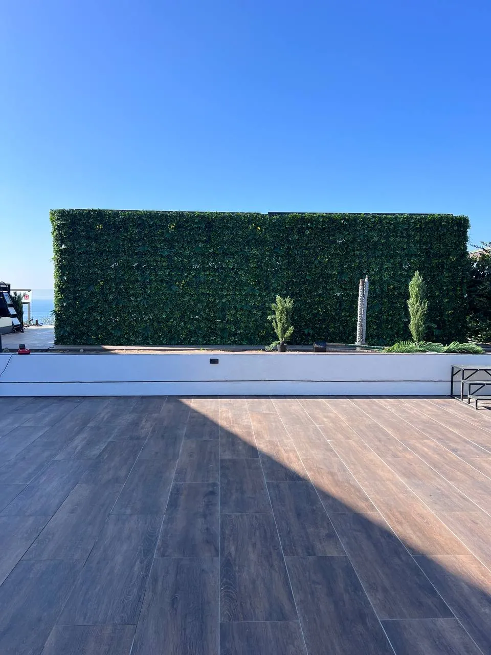 New deck and artificial turf in a compact backyard