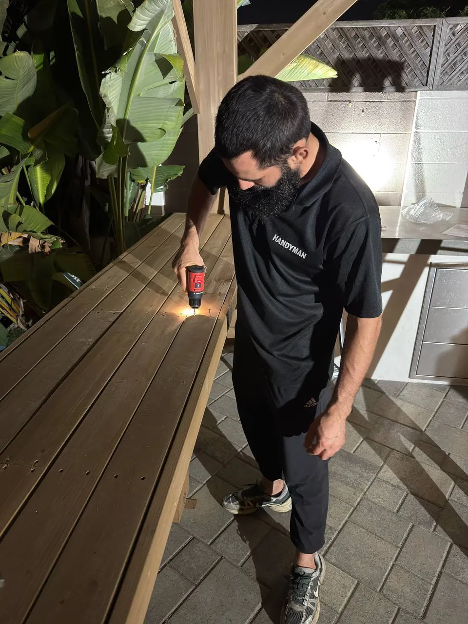 Easy Break Service handyman laying deck boards in San Diego