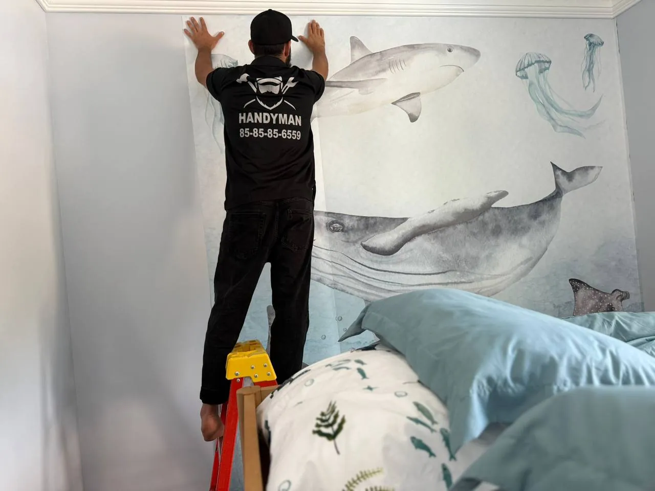 Branded Easy Break Service handyman patching a wall